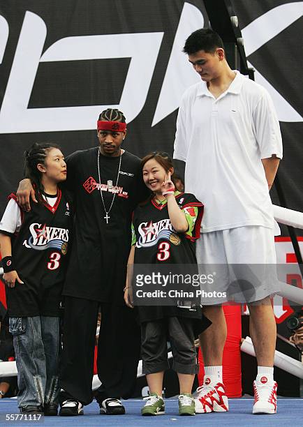 Star Allen Iverson of USA and Yao Ming of China pose for pictures with fans during an event at Shanghai Stadium on September 25, 2005 in Shanghai,...
