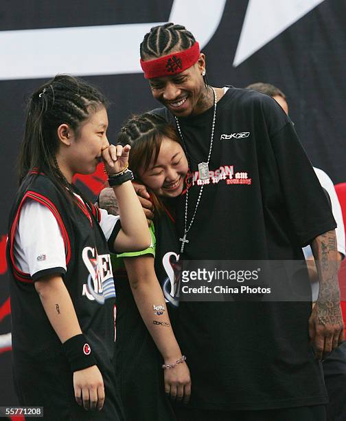 Star Allen Iverson of USA poses with fans during an event at Shanghai Stadium on September 25, 2005 in Shanghai, China. Philadelphia 76ers guard...
