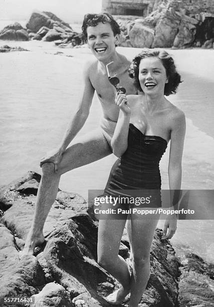 Actors Ulla Jacobsson and Folke Sundquist , stars of 'One Summer of Happiness', laughing together on a beach, April 28th 1952.