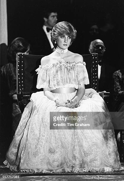 Diana, Princess of Wales, sitting down wearing a ball gown and pearl choker, circa 1985.