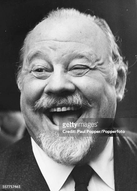 Portrait of American actor and singer Burl Ives laughing, during a visit to a pub in London, June 5th 1959.