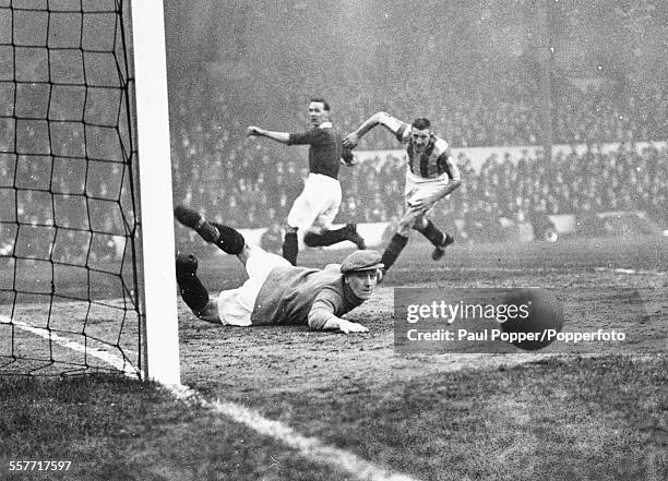 Stoke City goalkeeper Dick Williams diving to save a goal from Arsenal player David Jack during a football game between the Arsenal and Stoke City at...