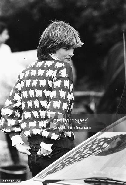 Diana, Princess of Wales, wearing jeans and a sheep print sweater, attending a polo match at Windsor, circa 1985.