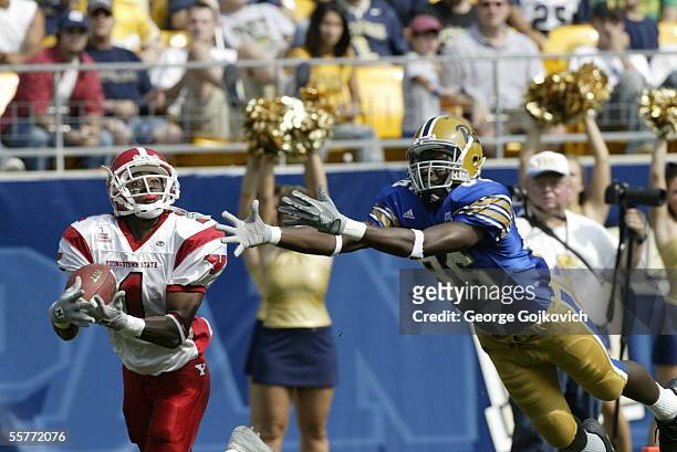 Defensive back Jason Perry of the Youngstown State Penguins intercepts a pass against wide receiver Greg Lee of the University of Pittsburgh Panthers...