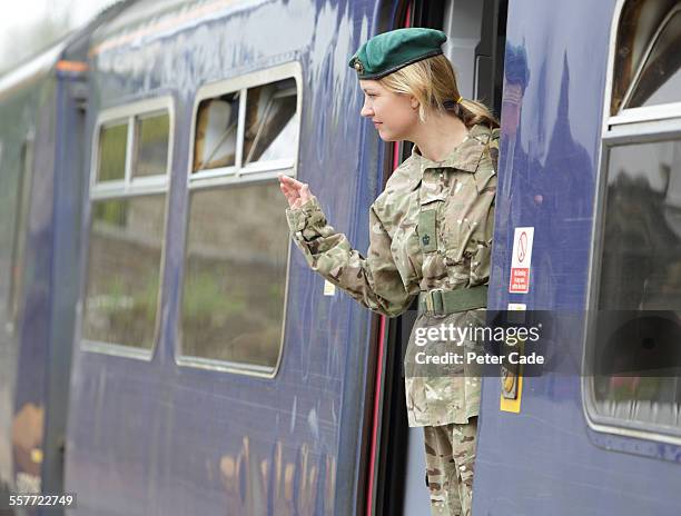 military woman leaving for service ,train station, - uk army stock pictures, royalty-free photos & images