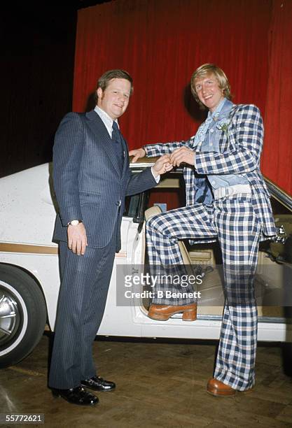 January 29: Garry Unger of the St. Louis Blues, dressed in a checkered suit and high heeled boots, receives keys to a new car from an unidenified man...