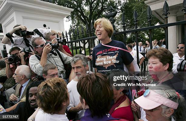 Anti-war activist Cindy Sheehan shouts to supporters while requesting a meeting with U.S. President George W. Bush at the Northwest Gate in front of...