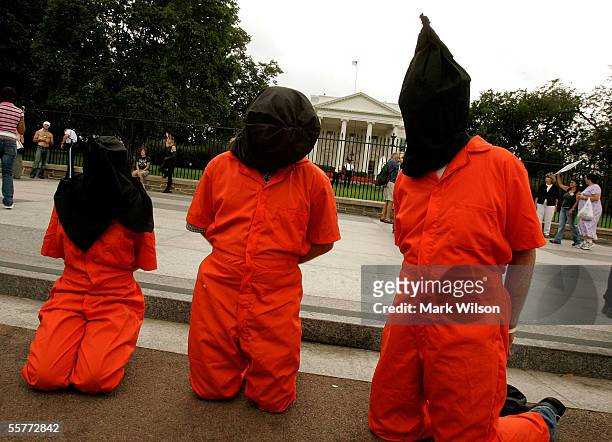 Anti-War protesters wear Abu Ghraib prison garb during a protest in front of the White House September 26, 2005 in Washington, DC. Anti-War protester...
