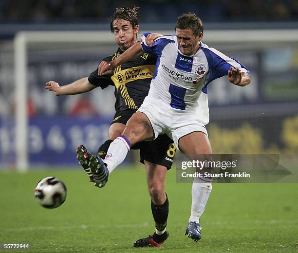 Bernd Gerd Rauw of Aachen battles for the ball with Marcel Schied of Rostock during the match of the Second Bundesliga between FC Hansa Rostock and...