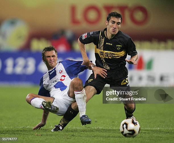 Laurentiu Reghecampf of Aachen battles for the ball with Marcel Schied of Rostock during the match of the Second Bundesliga between FC Hansa Rostock...