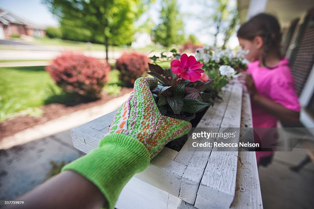 Mother and daughter planting flowers
