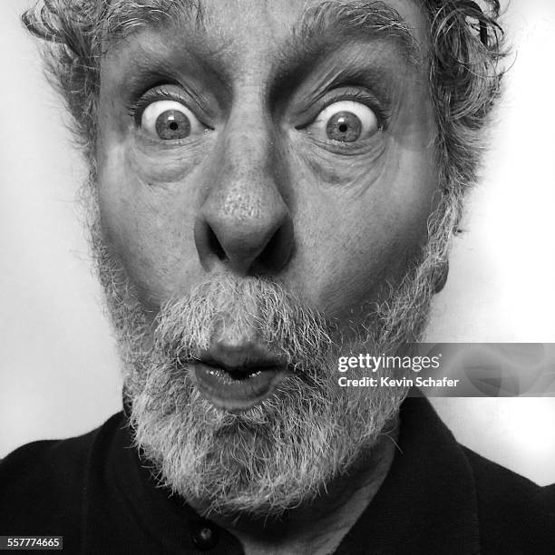 self-portrait of photographer age 64, mobile - funny photographer studio stock-fotos und bilder