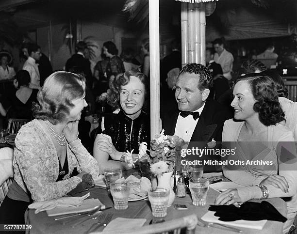 Actress Madge Evans and Paulette Goddard attend an event with friends in Los Angeles, California.