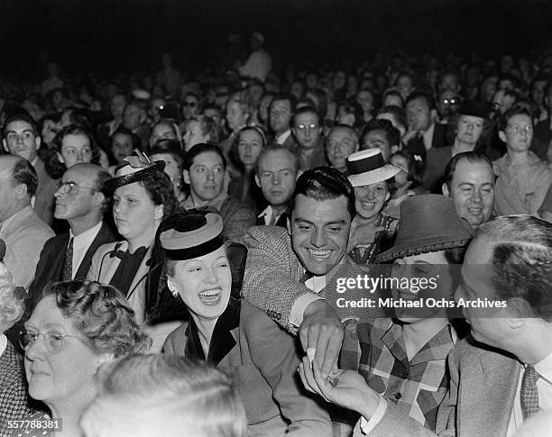 Actor Greg Bautzer and actress Lana Turner laugh during an event in Los Angeles, California.