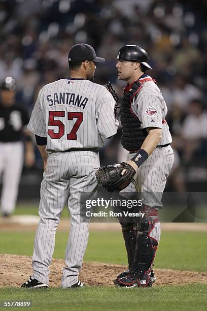 Johan Santana of the Minnesota Twins meets with catcher Mike Redmond during the game against the Chicago White Sox at U.S. Cellular Field on August...