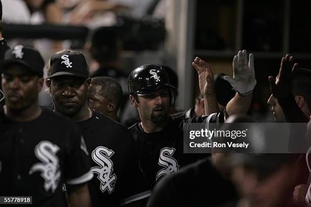 Paul Konerko of the Chicago White Sox is greeted in the dugout during the game against the Minnesota Twins at U.S. Cellular Field on August 17, 2005...