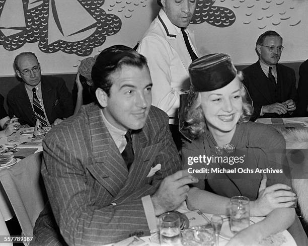 Actor John Payne and his wife actress Anne Shirley pose as they have lunch in Los Angeles, California.