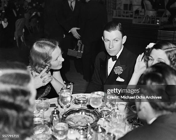 Actor George Murphy and actress Jean Arthur attend an event in Los Angeles, California.