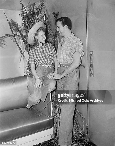 Actress Anne Shirley and husband actor John Payne pose during a party in Los Angeles, California.