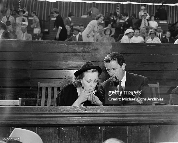 Actress Ann Sothern and Reginald Owen attend a tennis match in Los Angeles, California.