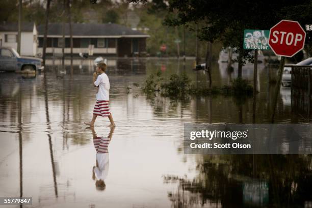 Young boy wades through streets flooded by Hurricane Rita September 26, 2005 in Delcambre, Louisiana. Rita, a category 3 hurricane, hit land near the...