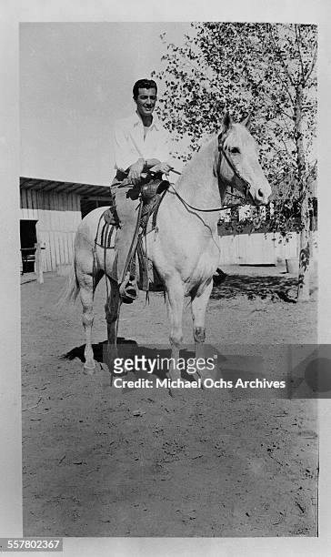Actor Robert Taylor poses on his horse in Los Angeles, California.