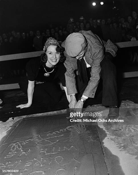 Actress Eleanor Powell has her hand print added to cement in front of Grauman's Chinese Theatre with the help of Jean W. Klossner in Los Angeles,...