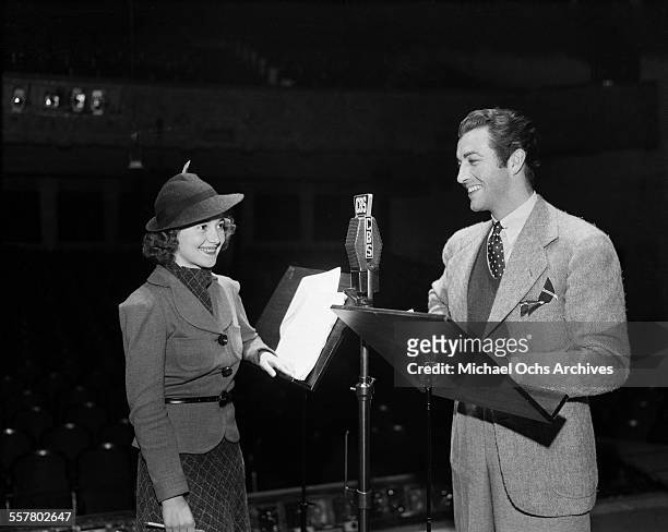Actor Robert Taylor and actress Olivia de Havilland at CBS radio station in Los Angeles, California.
