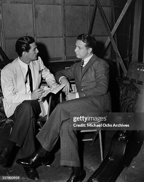 Actor Dick Powell is interviewed on set in Los Angeles, California.