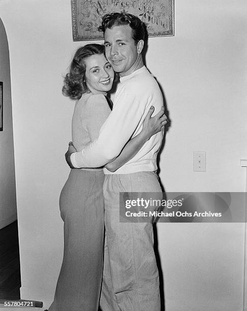 Actor Dick Powell poses with his wife actress Joan Blondell in Los Angeles, California.