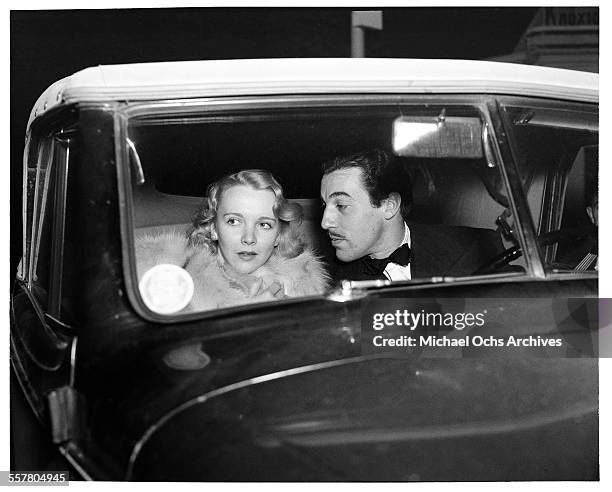 Actor Cesar Romero drives with Virginia Bruce to an event in Los Angeles, California.