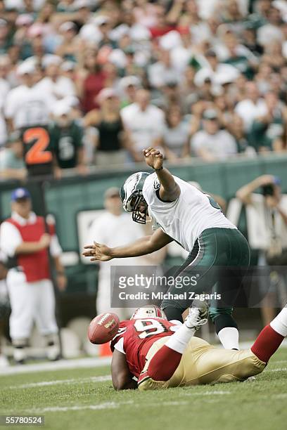 Marques Douglas of the San Francisco 49ers tackles Donovan McNabb of the Philadelphia Eagles and causes a fumble during the NFL game at Lincoln...