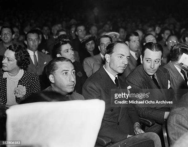 Actors William Powell and George Raft sit together during an event in Los Angeles, California.