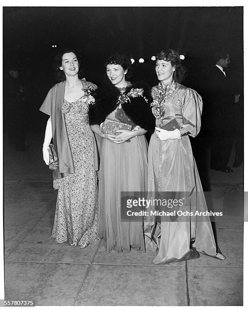 Actresses Rosalind Russell, Nedda Harrigan and Charlotte Wynters walk to an event in Los Angeles, California.