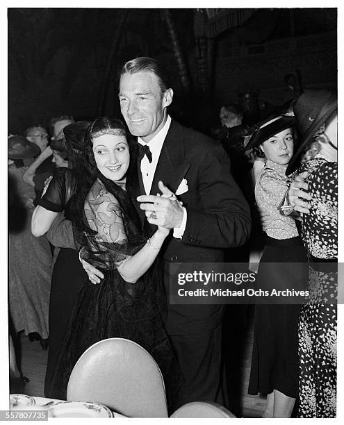 Actor Randolph Scott dances with actress Dorothy Lamour at an event in Los Angeles, California.