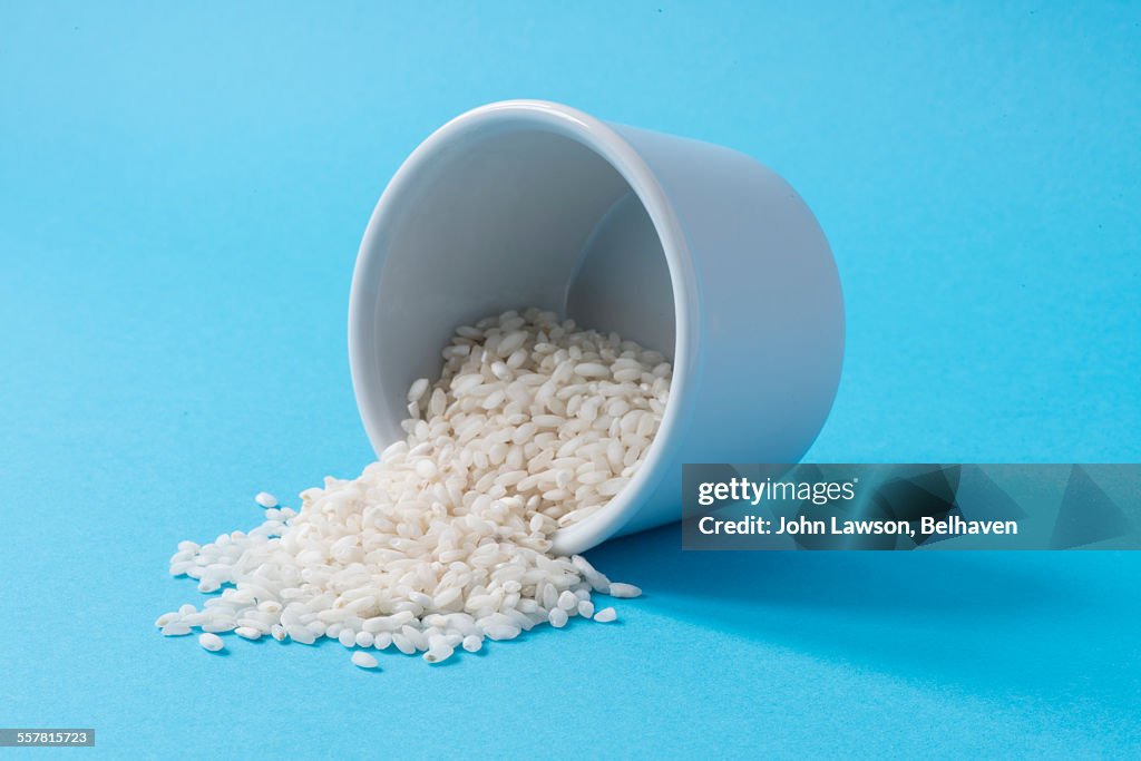 Arborio rice spilling from a white dish