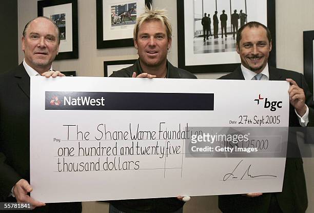 Cricket star Shane Warne collect their donations of USD 125,000 from Lee Amaitis and Shaun Lynn, Chairman and President of BGC and Partners, global...