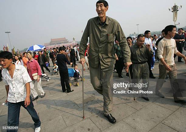 Bao Xishun, a Chinese man who measures 2.361 meters walks during a sightseeing event at the Tiananmen Square September 27, 2005 in Beijing, China....