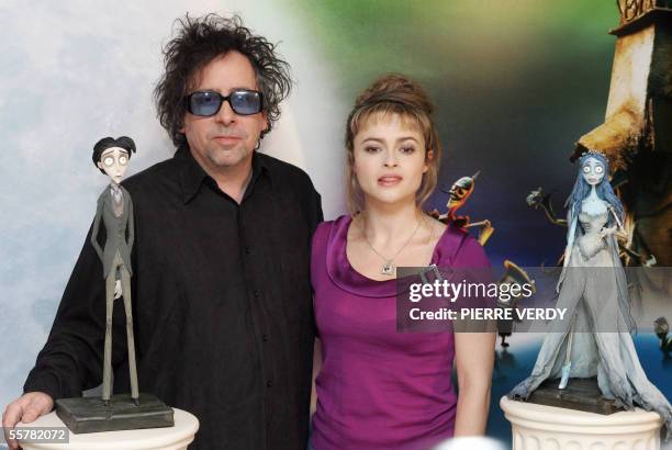 Film director Tim Burton and his wife Helena Bonham Carter pose with replicas of the characters of his animation film "Corpse Bride", 27 September...