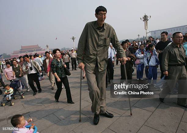 Bao Xishun, a Chinese man who measures 2.361 meters walks during a sightseeing event at the Tiananmen Square September 27, 2005 in Beijing, China....