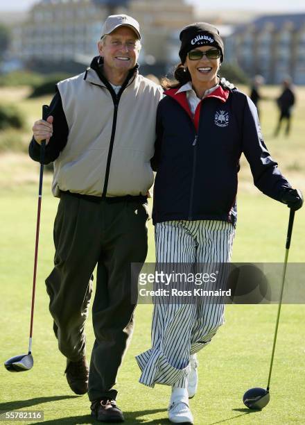 Film Star Michael Douglas and his wife Catherine Zeta-Jones walk down the 4th fairway during a practice round prior to the Dunhill Links...
