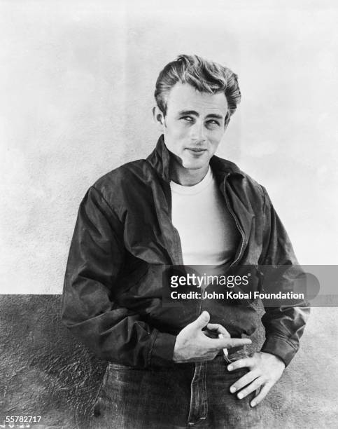 American actor James Dean leaning against a wall on the set of director Nicholas Ray's film, 'Rebel Without a Cause', 1955.