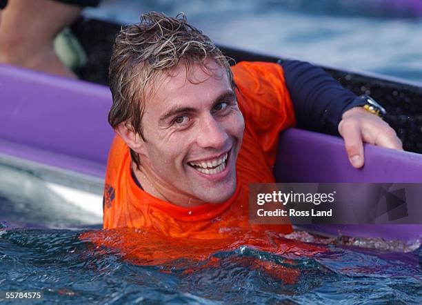 All Black Justin Marshall enjoys a dip after his crews boat capsized during an outrigger canoe sprint challenge for the All Blacks at Pilot Bay in Mt...