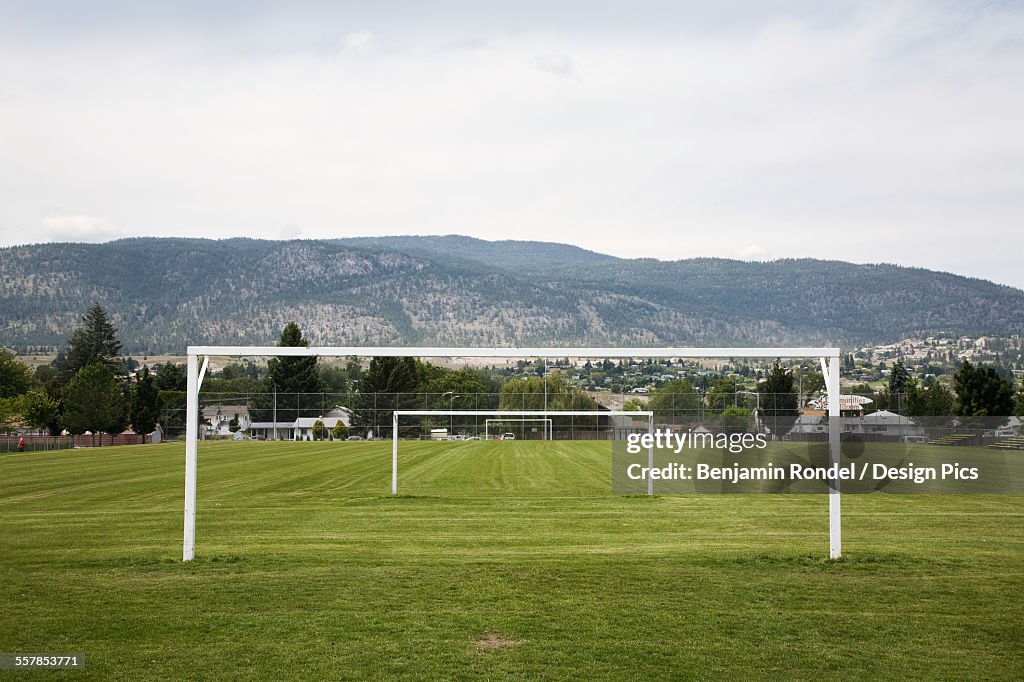 Goal posts in a row in a grass recreation field