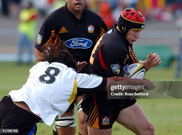 Chiefs Mark Ranby is caught by Hurricanes Rodney So'oialo in a pre season Super 12 Rugby game at the Levin Domain, Friday.