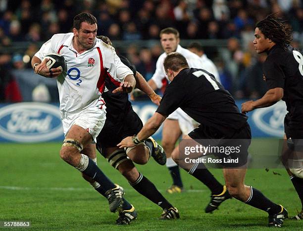 Captain Martin Johnson runs the ball up as Richard McCaw and Rodney so'oialo chase during England's 1513 win in over the All Blacks in their rugby...