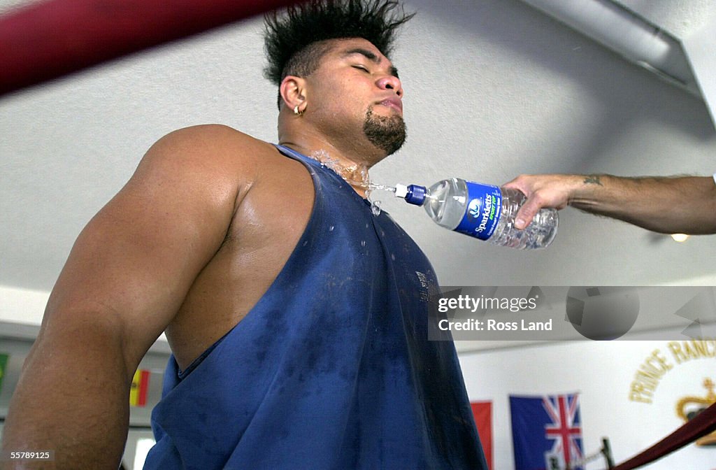 David Tua cools off with water, during training in