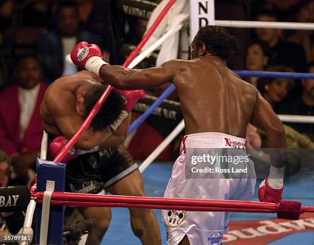 Tua Rope David Tua covers up as he is knocked through the ropes by world... News ...