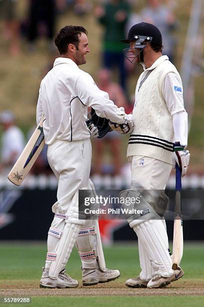 New Zealand's Craig McMillan, right, congratulates Nathan Astle on his century on the second day of the Black Caps Cricket test against Zimbabwe at...