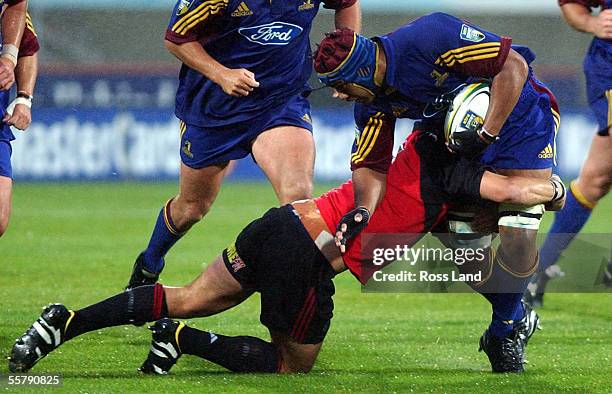 Felipo Levi is tackled by Richard McCaw, during the Super12 rugby match between the highlanders and Crusaders at Carisbrook, Dunedin, Saturday....